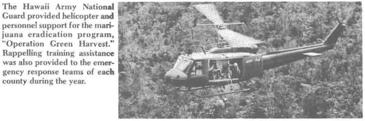 Page from the 1984 State of Hawaii Department of Defense annual report: text noting the Hawaii Army National Guard provided helicopter and personnel support for the marijuana eradication program Operation Green Harvest, beside a photo of a UH-1 Huey flying low over dense jungle canopy
